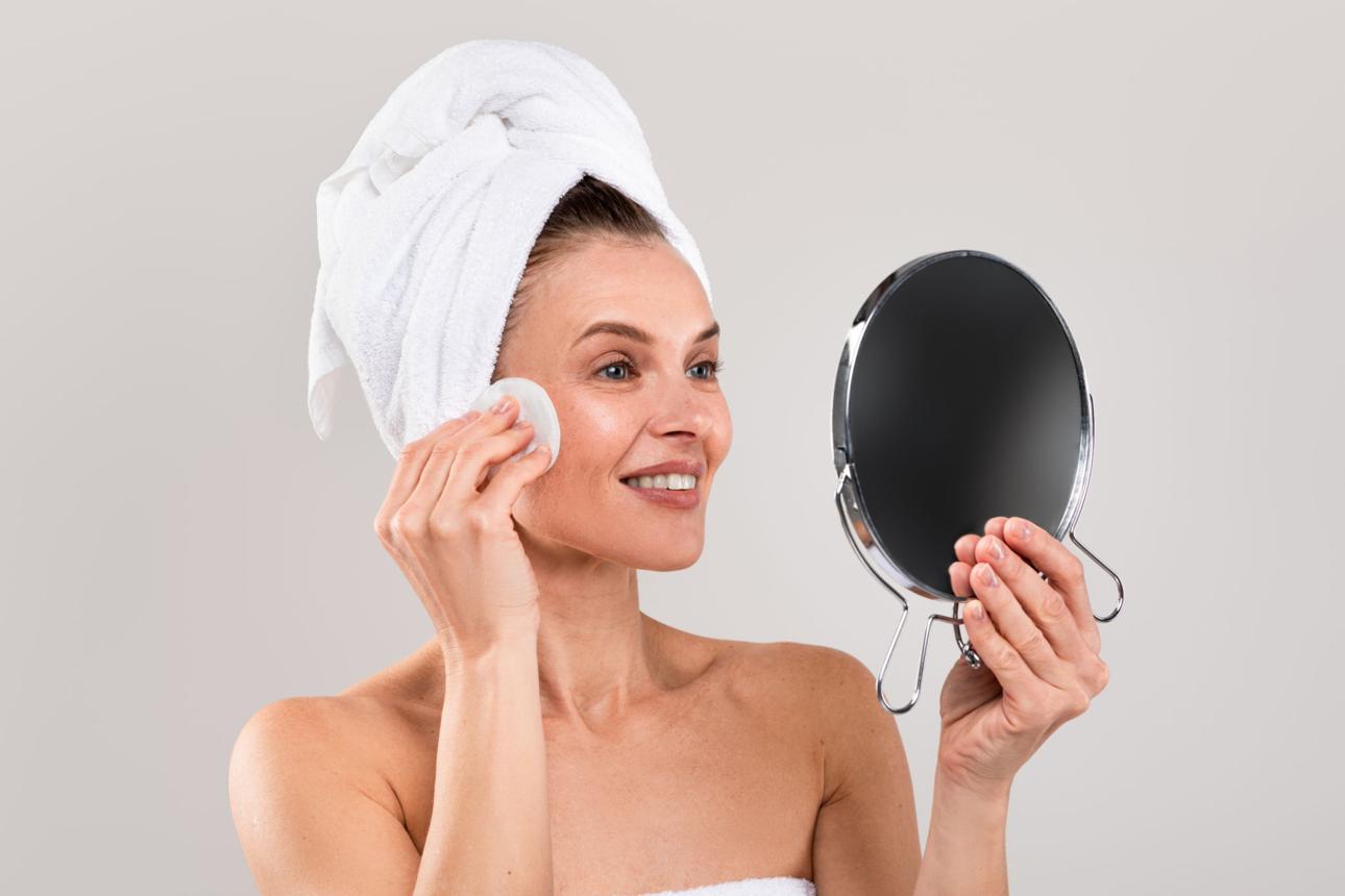 Woman applying natural skincare to soothe itchy menopausal skin